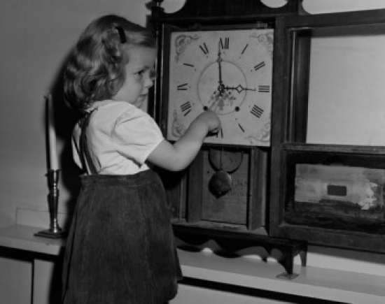 Girl Adjusting Clock Poster Print - 18 x 24 in.