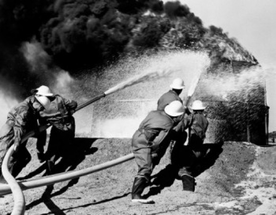 Firemen Fighting Oil Fire Poster Print - 18 x 24 in.