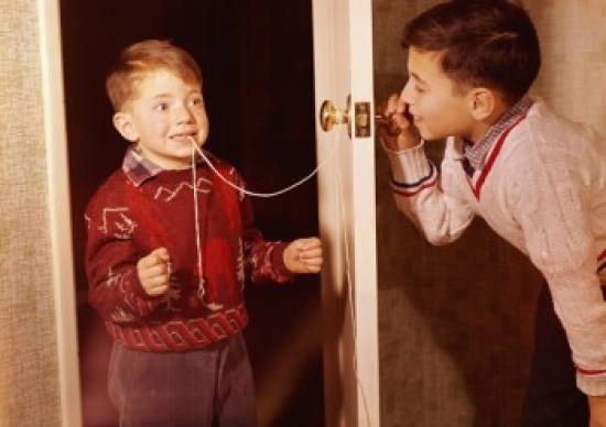 Boy Attempting to Extract His Brothers Loose Tooth Using String & Doorknob Technique Poster Print - 18 x 24 in.
