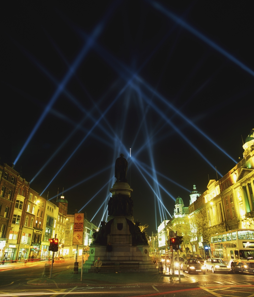 Spire of Dublin OConnell Street Dublin Ireland - Eu Celebrations with Searchlights in Night Sky Poster Print by The Irish Image Collection, 14 x 16