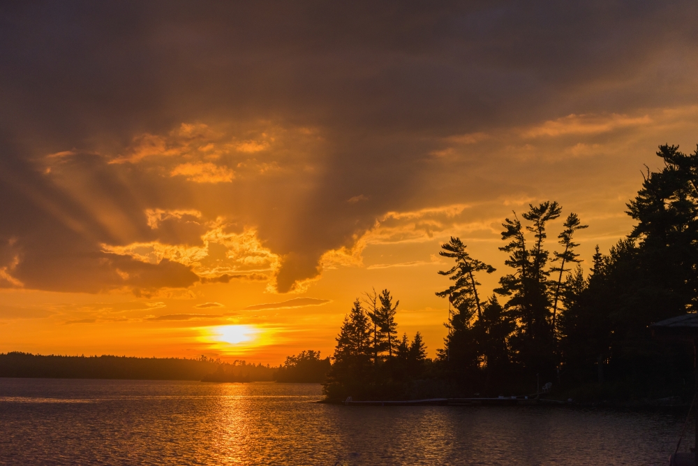DPI12303003 Sunrise Casting An Orange Glow Over The Sky & Reflected in a Tranquil Lake - Ontario Canada Poster Print by Keith Levit, 19 x 12