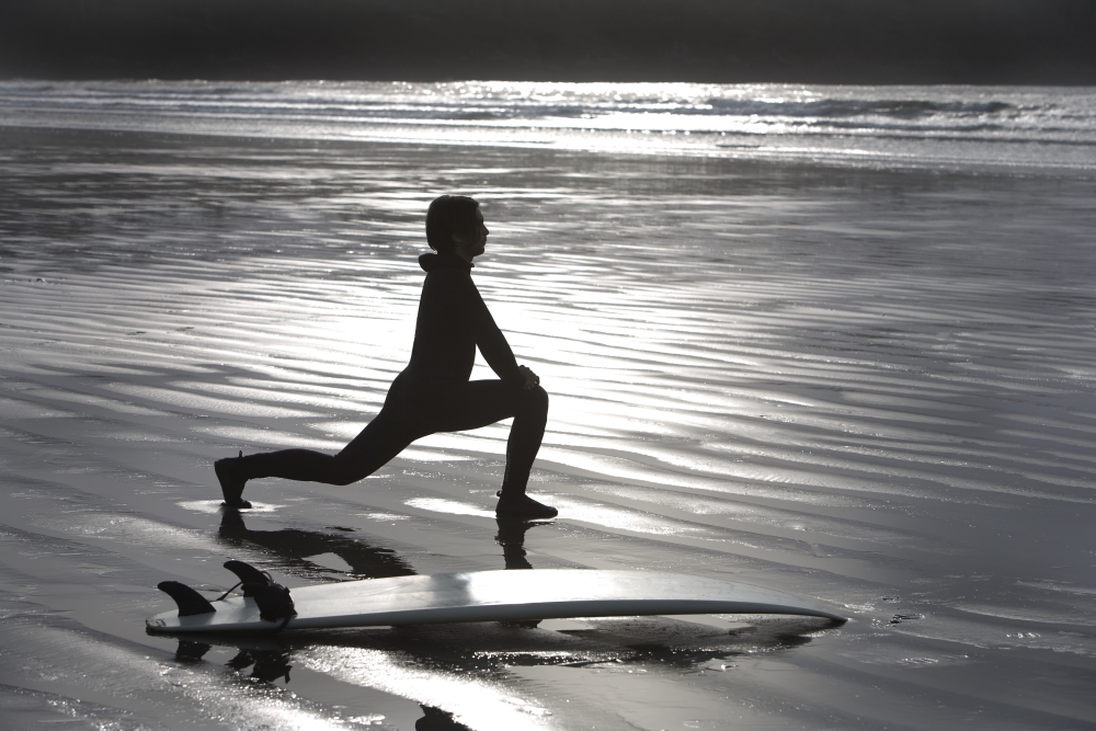 Surfer Stretching On Beach Poster Print by Deddeda, 34 x 22 - Large