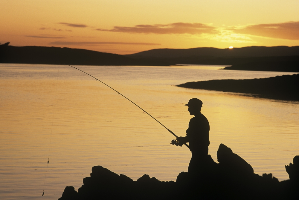 Silhouette of A Fisherman Fishing On The Coast Roaring Water Bay County Cork Republic of Ireland Poster Print by The Irish Image Collection - 18 x 12