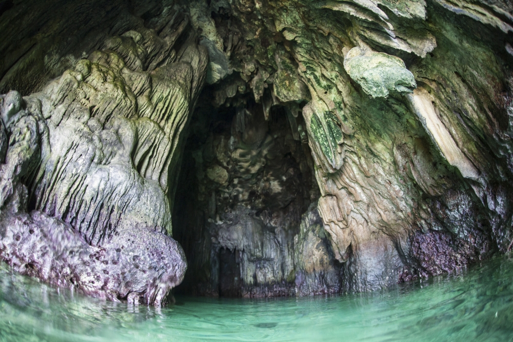 A Cave Has Formed Inside A Limestone Island in Raja Ampat Indonesia. Caves Are Formed by Carbonic Acid Eroding The Limestone Poster Print - 17 x 11