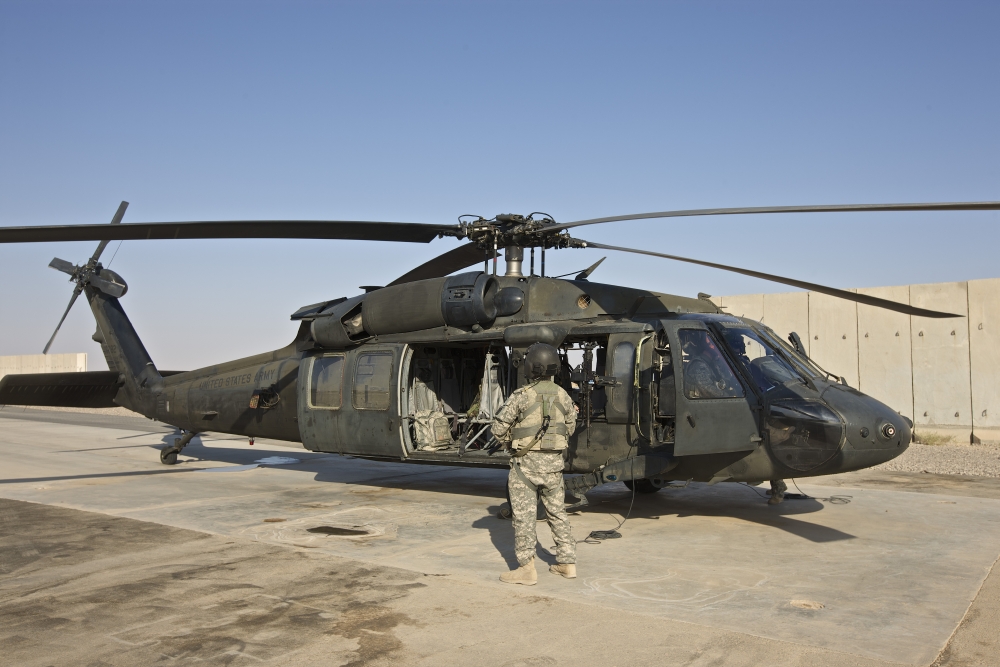 A U.S. Army Crew Chief Stands by While Pilots Go Through Their Pre-Start Checks On A Uh-60 Black Hawk Tikrit Iraq Poster Print, 17 x 11
