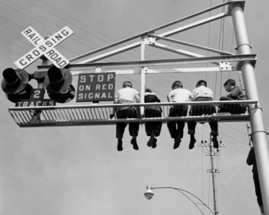Superstock SAL2554692 Low Angle View of Children Sitting On A Railroad Crossing Signal Poster Print, 18 x 24