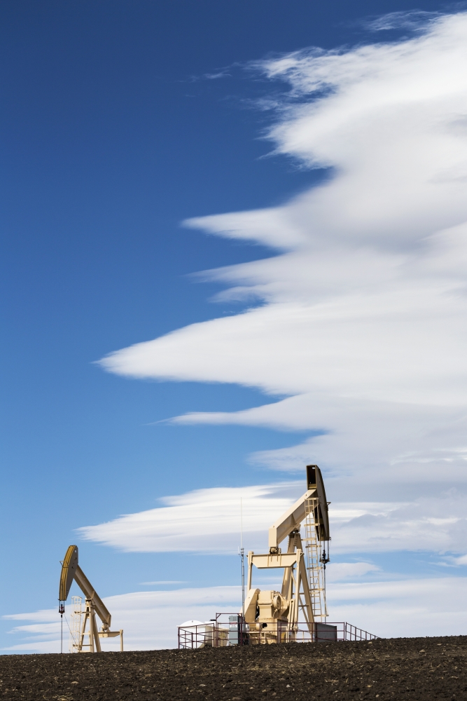 Two Pumpjacks on A Hill with Dramatic Clouds in The Blue Sky - Alberta Canada Poster Print - 12 x 19 in.