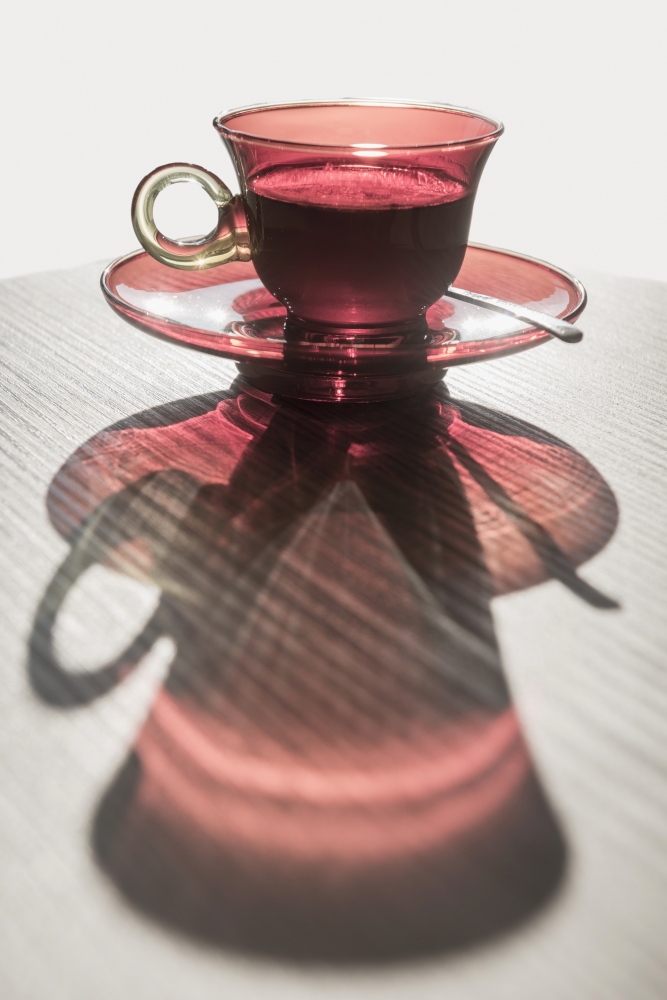 A Red Glass Cup A Saucer with A Beverage Reflected on A White Surface - Locarno Ticino Switzerland Print - 24 x 38 in. - Large