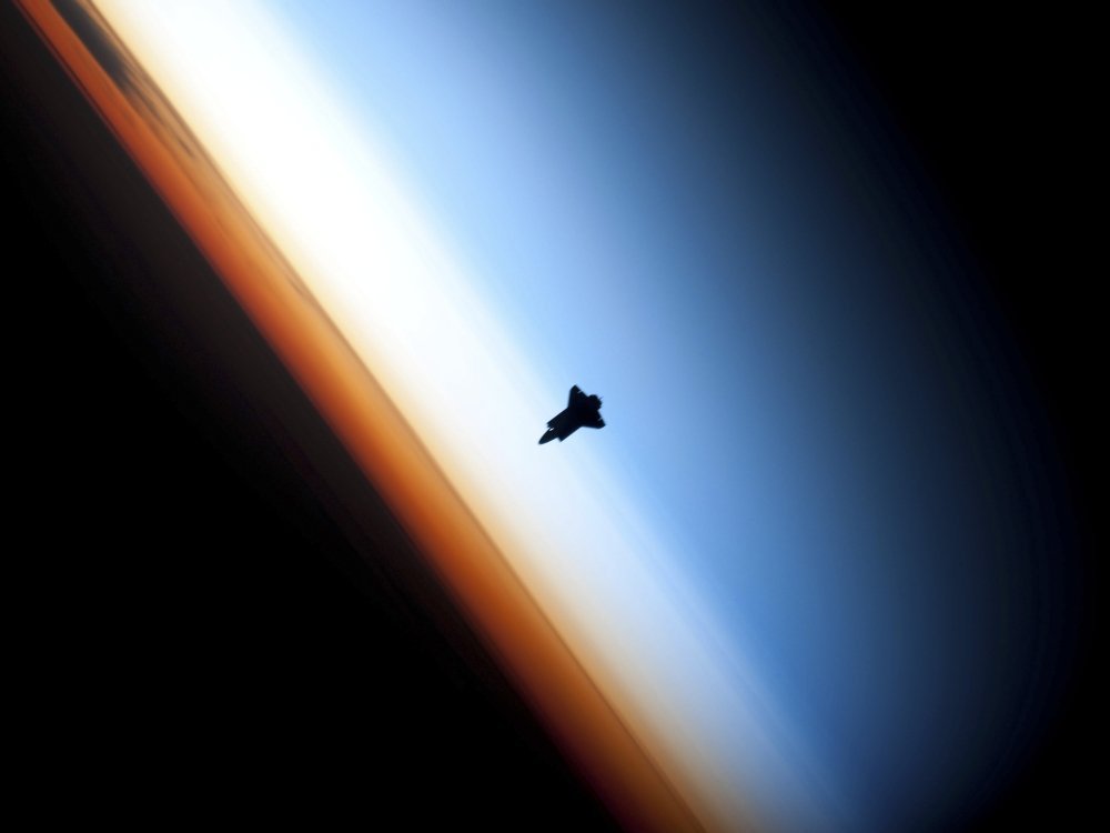 StockTrek Images PSTSTK203207S February 9 2010 - Silhouette of Space Shuttle Endeavour Over Earths Colorful Horizon Poster Print, 16 x 12