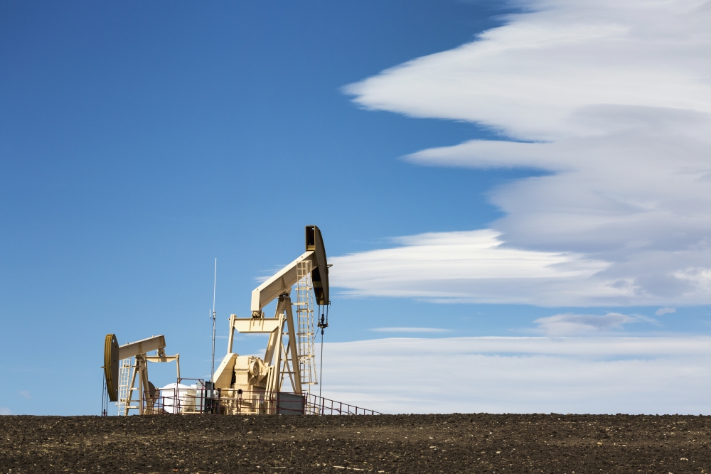 Two Pumpjacks on A Hill with Dramatic Clouds in The Blue Sky - Alberta Canada Poster Print - 19 x 12 in.