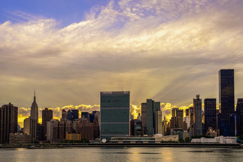 Sun Setting Behind United Nations - New York City United States of America Poster Print - 19 x 12 in.