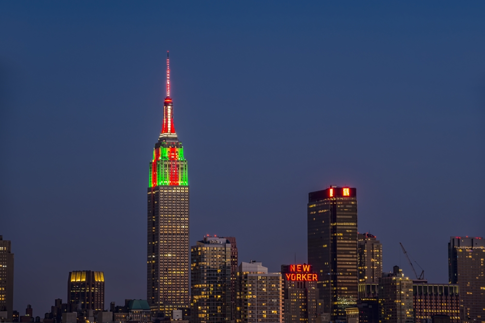 Empire State Building at Twilight in Colors Celebrating Christmas New York Poster Print - 19 x 12 in.