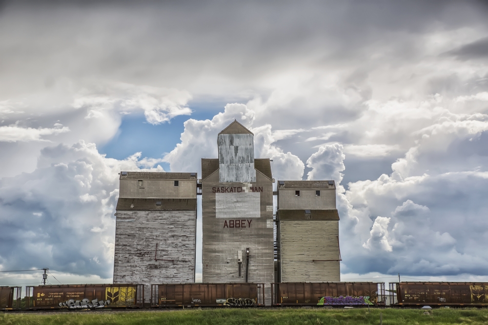 Rural Grain Elevator with Cumulonimbus Clouds Building Up Around It - Saskatchewan Canada Poster Print - 19 x 12 in.