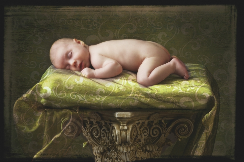 A Baby Asleep On A Pillar Poster Print - 18 x 12