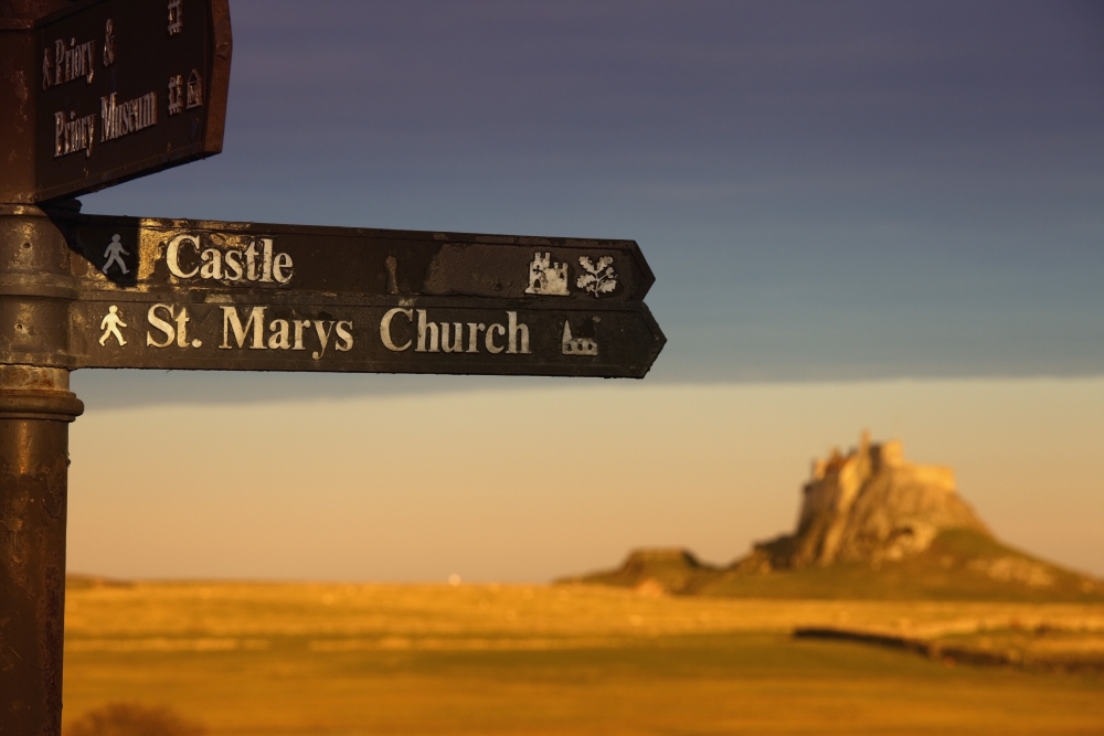 Picture of Posterazzi  A Sign Post Pointing to A Castle & St. Marys Church On The Tidal Island&#44; Also Known As Holy Island - Lindisfarne&#44; Northumberland&#44; England Poster Print&#44; 38 x 24 - Large