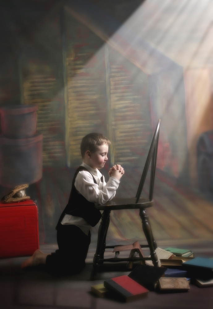 DPI1877047LARGE A Young Boy Praying with A Light Beam On Him - Victoria, British Columbia, Canada Poster Print, 22 x 34 - Large