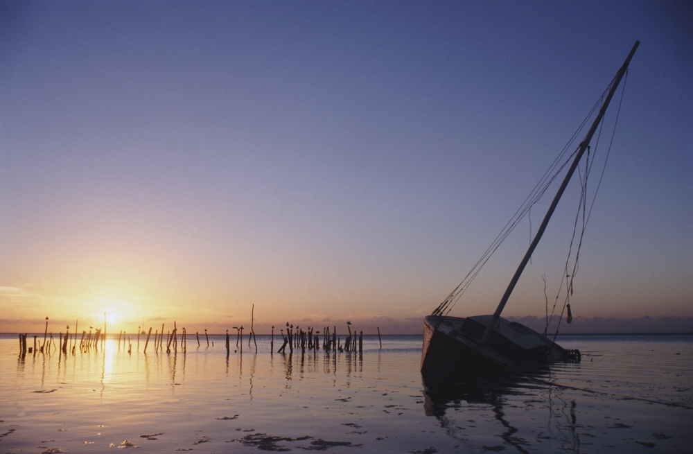 DPI1879032LARGE Partly Submerged & Keeling Sail Boat In Silhouette At Sunset Poster Print, 34 x 22 - Large