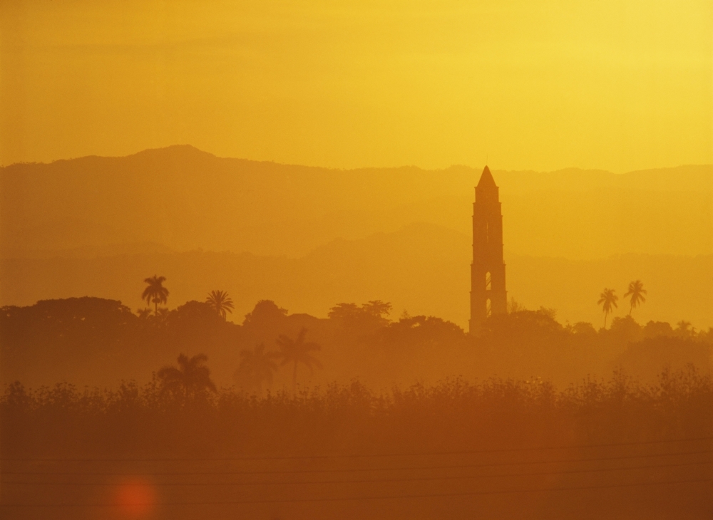 Tower Silhouetted Amongst Orange Mountains Poster Print - 16 x 12