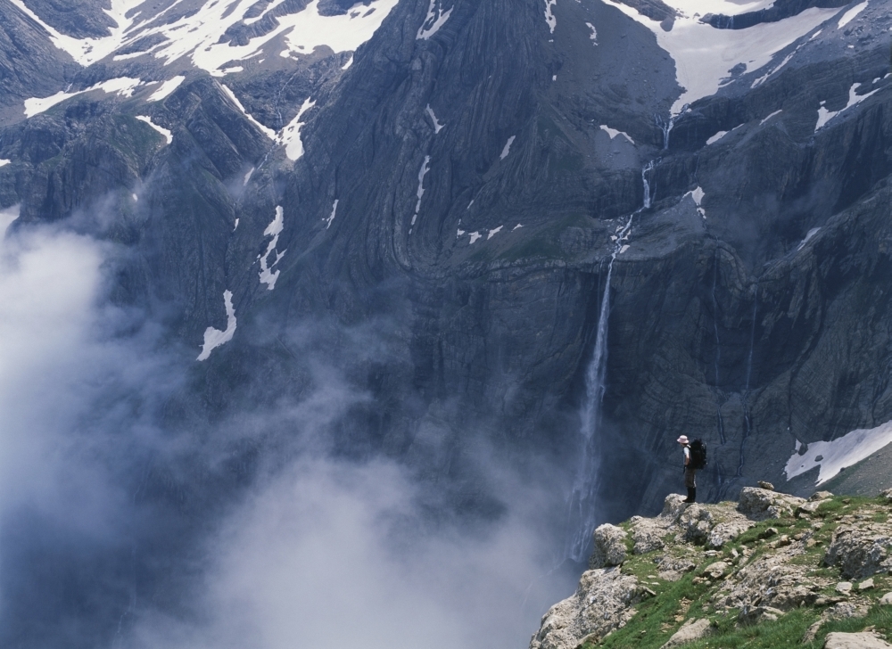 Walker Looking Over Waterfall At Cirque De Gavarnie Poster Print - 16 x 12