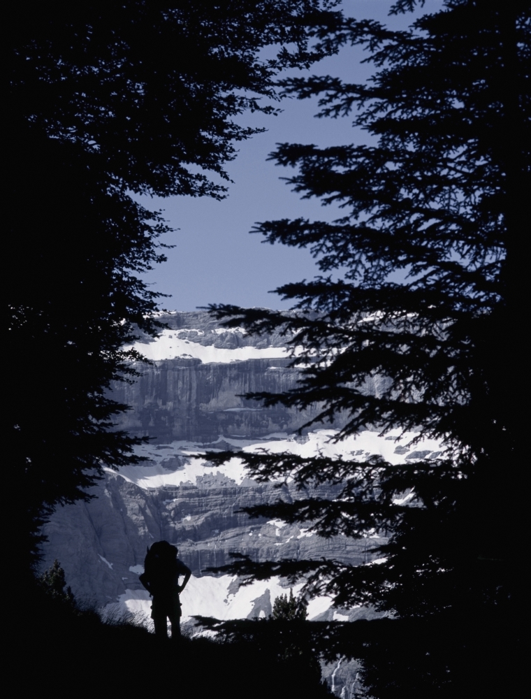 DPI1880877 Walker Climbing Up Hill Between Trees with The Cirque De Gavarnie Poster Print, 12 x 15