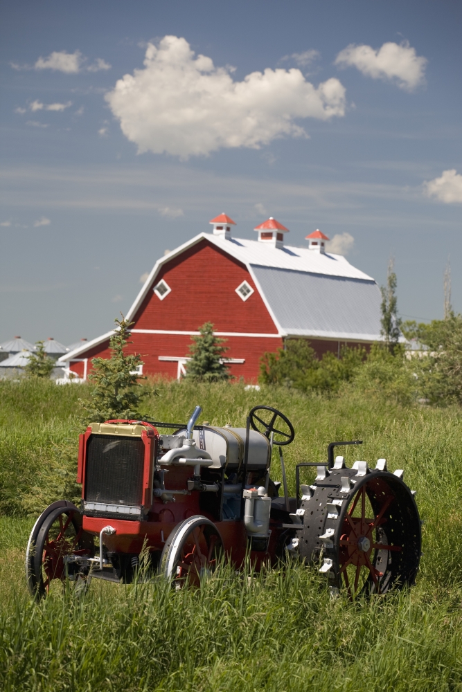 Old Red Tractor In A Field with A Red Barn In The Background - Alberta - Canada Poster Print - 12 x 19