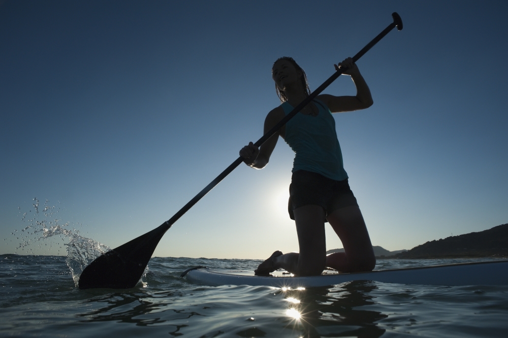 A Woman Paddling While On Her Knees On A Surf Board Off Dos Mares Beach - Tarifa - Cadiz - Andalusia - Spain Poster Print
