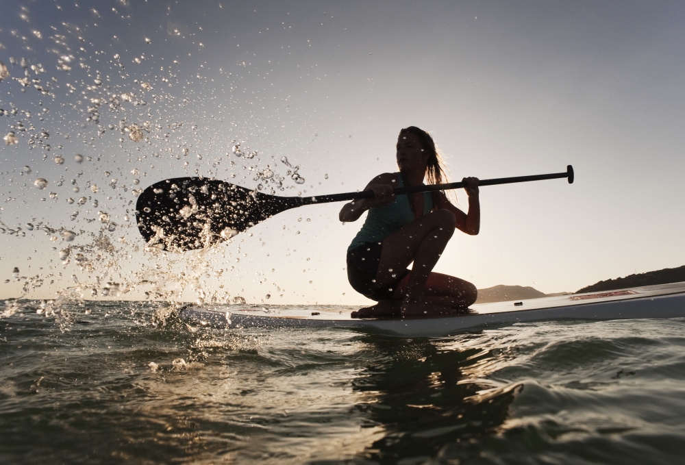 A Woman Paddling While On Her Knees On A Surf Board Off Dos Mares Beach - Tarifa - Cadiz - Andalusia - Spain Poster Print