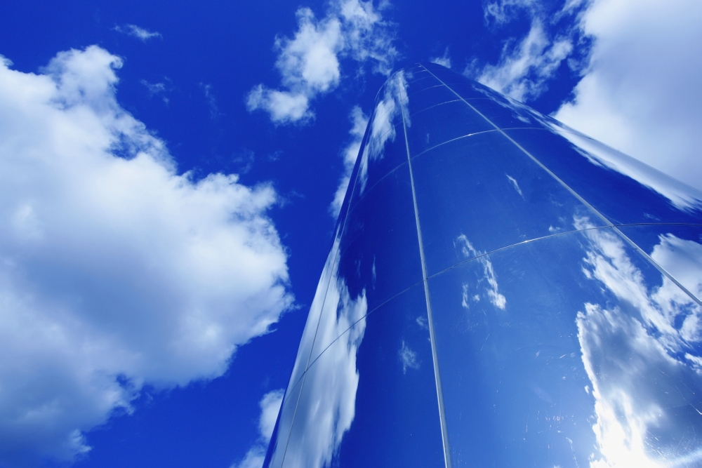 Glass Obelisk with Blue Sky & Cloud Reflections Poster Print