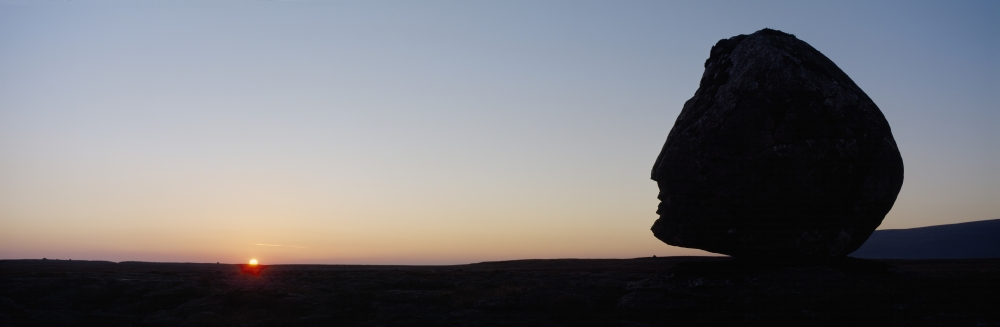 Silhouette of Head-Shaped Boulder At Dusk Poster Print