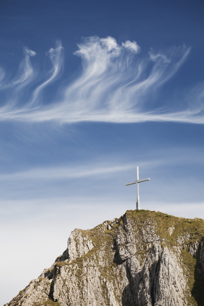 Mountain Peak with A Cross On Top Against A Blue Sky with Clouds - Fussen, Germany Poster Print, 12 x 19