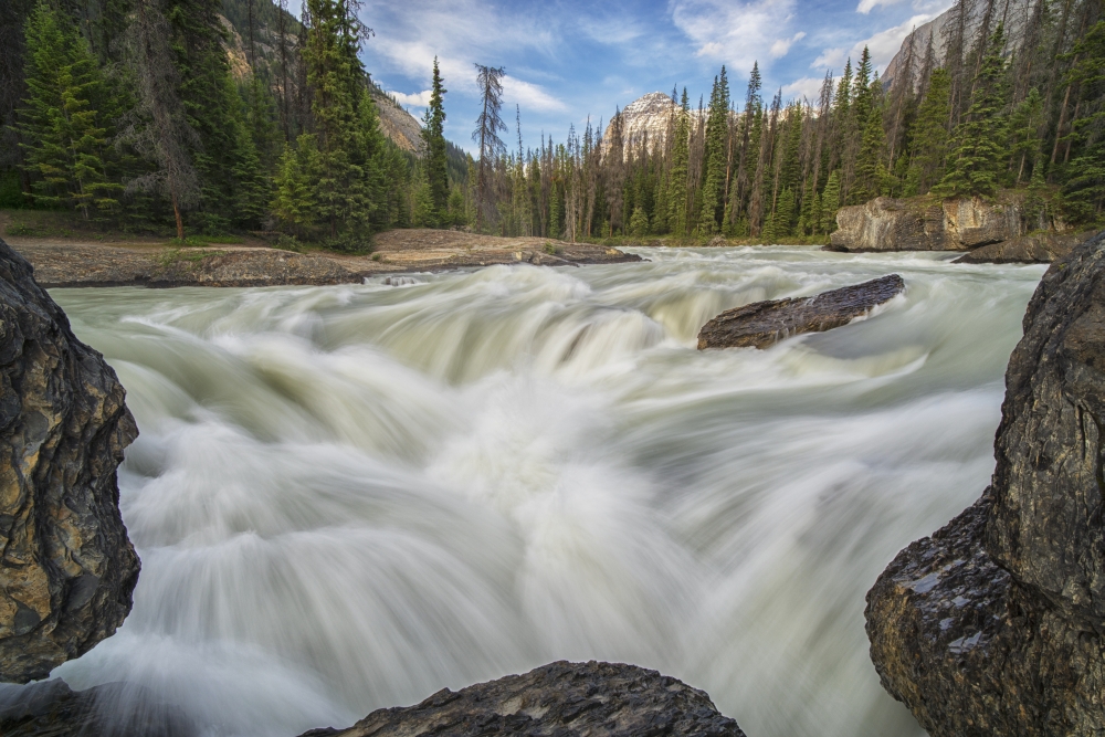 The Kicking Horse River Flows Over A Waterfall Before It Goes Beneath A Natural Bridge Yoho National Park Poster Print - 38 x 24 in. - Large