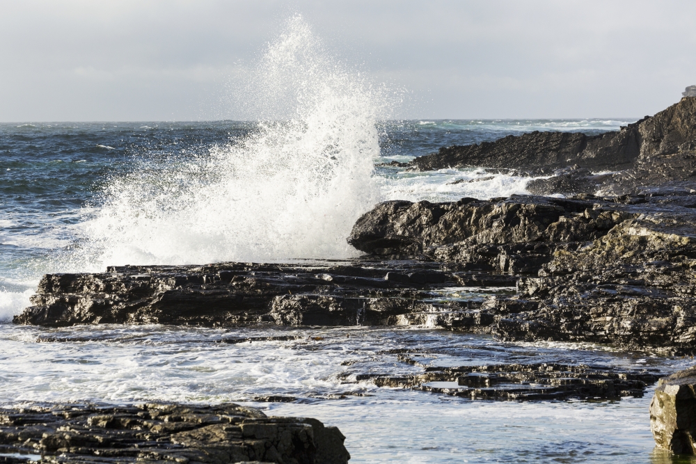 Wave Crashing Into Rocky Coast with Cloudy Sky - Kilkee County Clare Ireland Poster Print - 19 x 12 in.