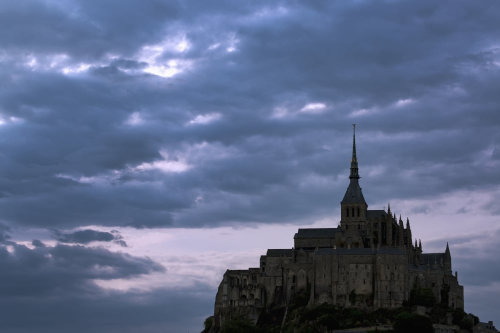 Silhouette of Large Stone Abbey Perched on Rocky Hill with Dramatic Clouds at Sunset Poster Print - 38 x 24 in. - Large
