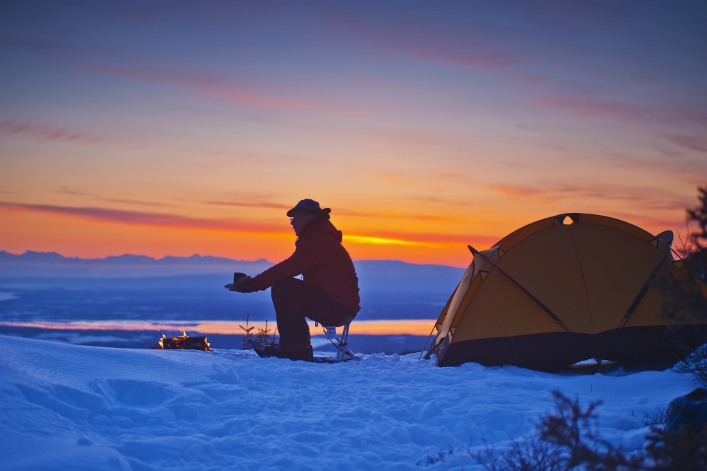 A Backpacker Warms His Hands Over A Campfire at A Campsite High in The Chugach Mountains Overlooking Kinik Arm & Cook Inlet Poster Print - 19 x 12 in.