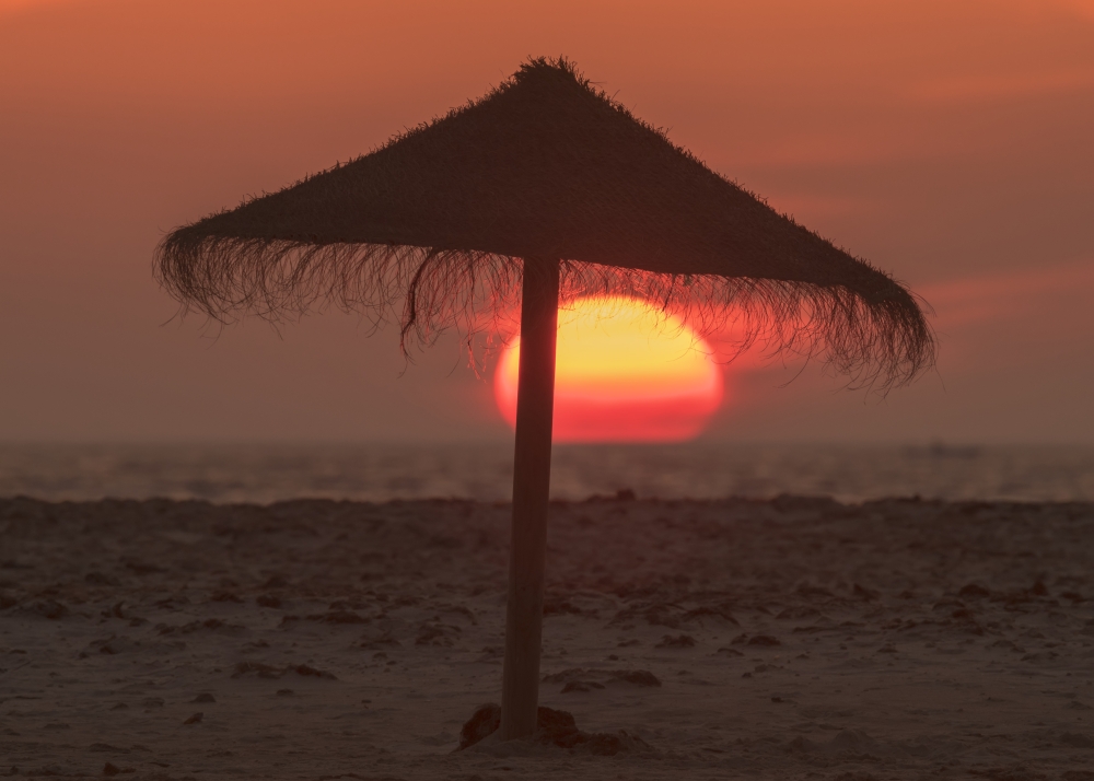 Silhouette of A Beach Umbrella on The Beach with A Colourful Sun Sinking Into The Horizon Over The Ocean 1 Poster Print