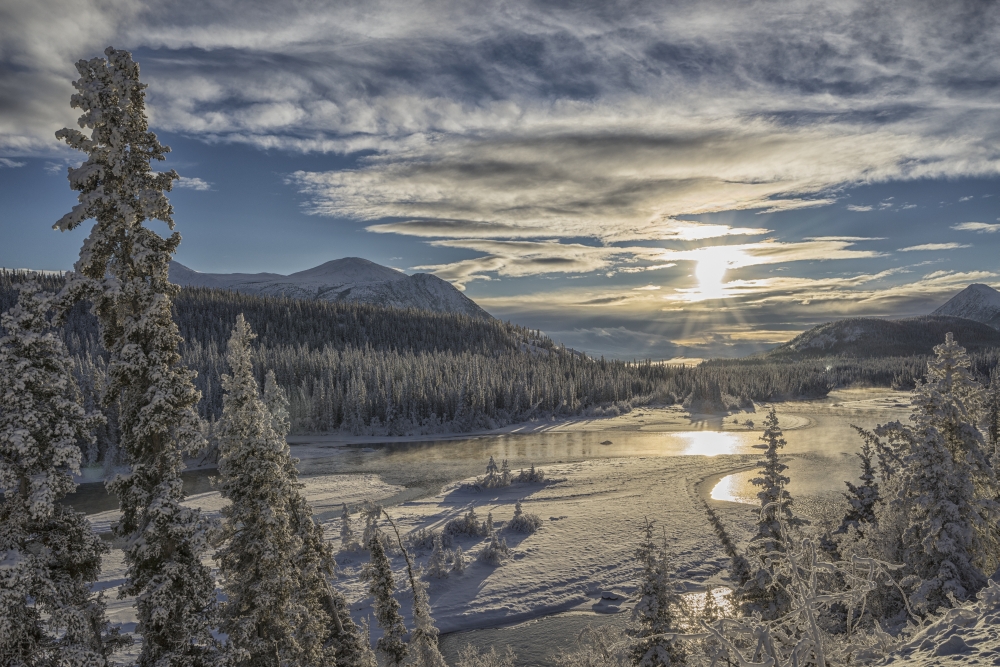The Sun Breaks Through The Clouds Above The Takhini River on A Late Winter Poster Print - 19 x 12 in.