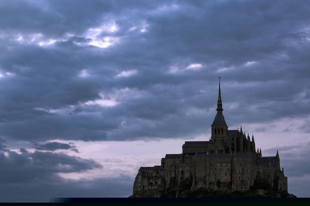 Silhouette of Large Stone Abbey Perched on Rocky Hill with Dramatic Clouds at Sunset Poster Print - 19 x 12 in.
